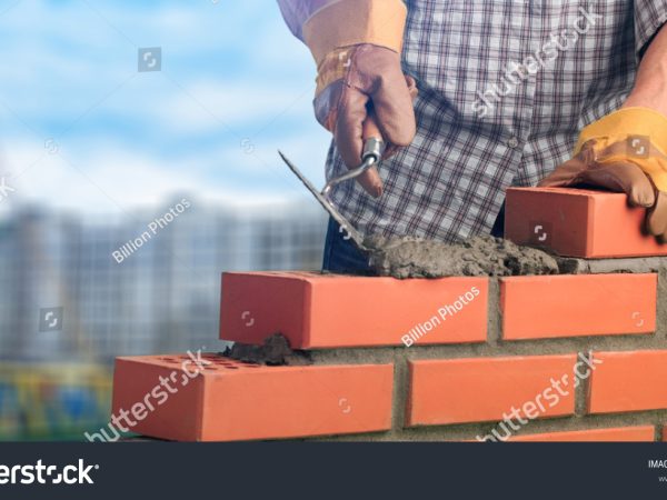 stock-photo-bricklayer-worker-installing-brick-masonry-1068034937